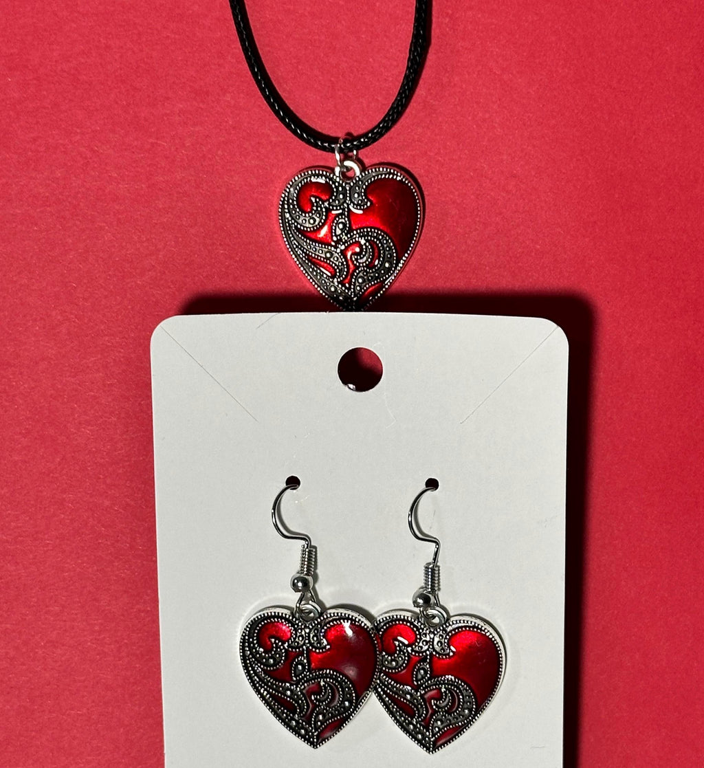 Red heart pendant necklace and matching dangle earrings on white card, red background