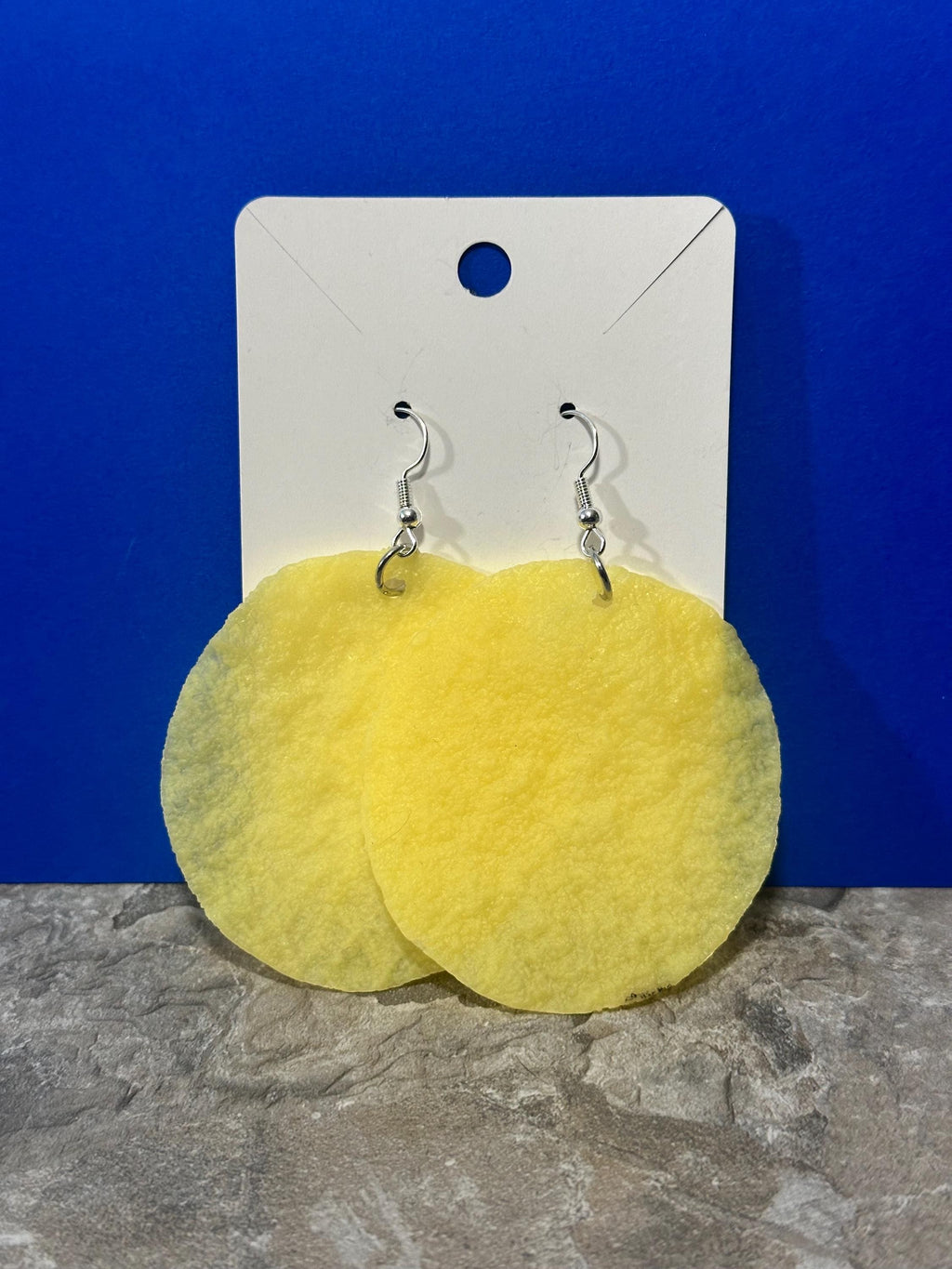 Plain yellow potato chip earrings without ridges on display card