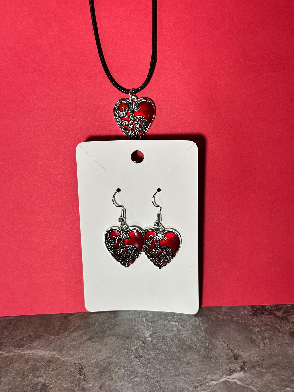 Red heart earring and pendant jewelry set on white display card