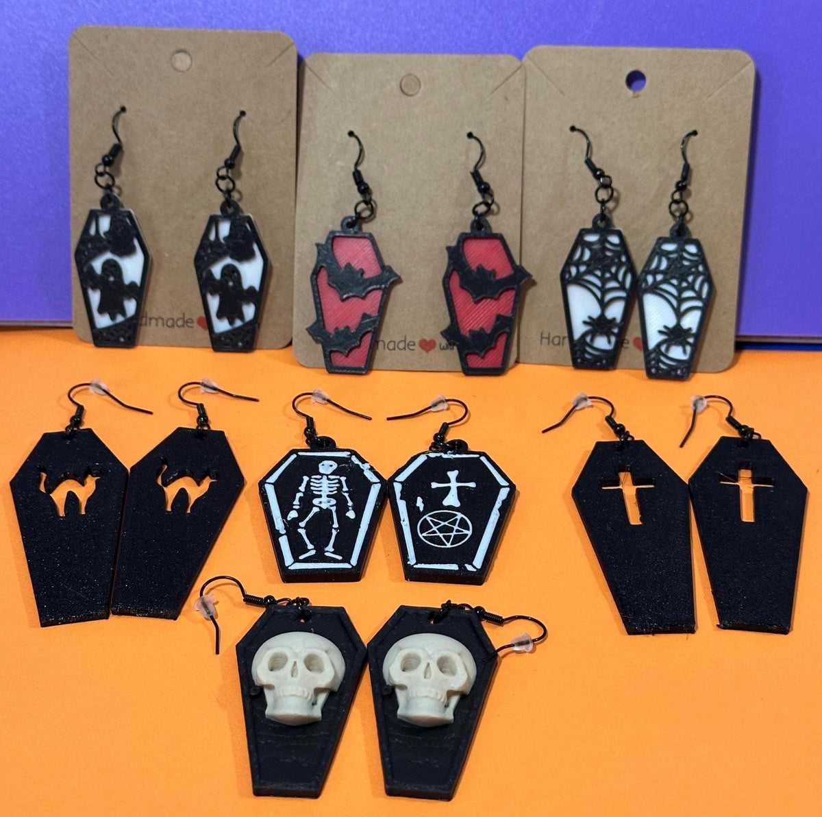 Eight pairs of 3D printed coffin earrings: ghost, bat, spiderweb, cat, skeleton, cross, skull designs