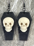 Black coffin dangle earrings with white skulls on black hooks