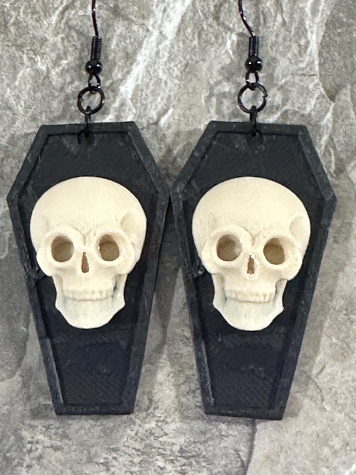 Black coffin dangle earrings with white skulls on black hooks